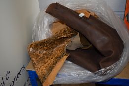 A collection of pieces and off cuts of leather,suede and other fabrics, useful for repairs or