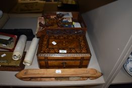 An antique inlaid wooden box with key, two carved oak desk top stacking shelves and a shuttle,