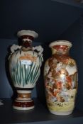 Two Japanese vase one having twin handle design and similar highly decorated with Samurai