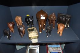 A selection of African tribal hand carved elephant figures and book end including ebony wood