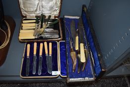 A selection of cutlery table and flatwares including boxed fruit knives and horn handle carver set
