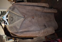 A vintage sheepskin coat having button front and pockets to sides,medium to large size.