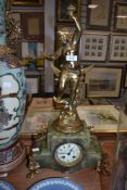 A continental marble effect mantle clock having gilded spelter cherub decoration.