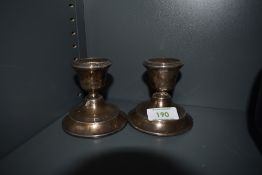A pair of HM silver candlesticks of plain squat form (AF)