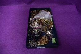 A selection of costume jewellery including bangles, brooches, tigers eye beads etc