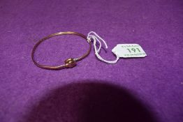 A yellow metal bangle having heart terminals, no marks tested as 9ct gold, approx 3.4g