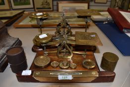 Two antique sets of brass and mahogany postal scales with weights, a spirit level and two brass
