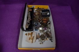 A small selection of gold and silver plated jewellery including pistol cufflinks, chains, diamante
