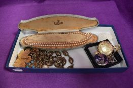 A selection of costume jewellery including pocket watches, leaf brooch, simulated pearls, Monet