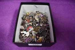 A large selection of pin badges, mainly animals and birds