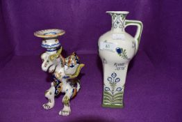 Two ceramics in Dutch designs including hand decorated figural dragon candle stick