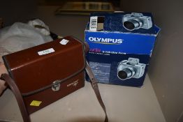 A set of Tasco binoculars and an Olympus Camedia digital camera.