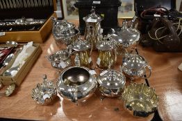 A collection of fine plated wares, including tea pots, jugs and sugar nips to name a few, around