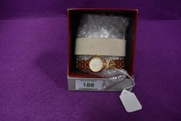 A lady's Junghans gold plated wrist watch having baton dial and bracelet strap