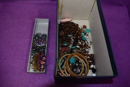 A selection of costume jewellery including enamelled hair slides and brooch, bead necklace etc