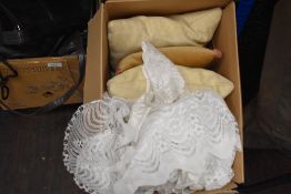 Three feather cushions and a selection of net curtains.