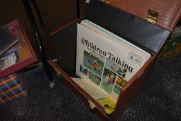 A retro vinyl storage carry case housing a collection of childrens LP records,45's and shellac