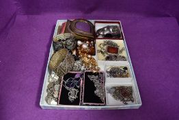 A selection of costume jewellery including pendants, wrist watches, bracelets, brooches etc