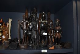 An selection of hand carved African tribal figures and totems including Ghana, Maasai and Zulu