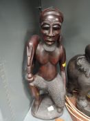 A large hand carved figure of an exotic hunter possibly Indonesian standing