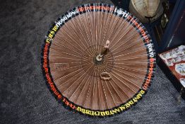 A vintage advertising parasol for Malaysian airline systems reading 'Flies to Hong Kong(10 times