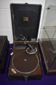 An antique gramophone shellac record player by HMV in good condition with arm winder