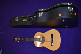 A Junior classical guitar, labelled Lauren, and an oversized hard case