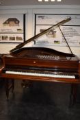 A traditional mahogany cased baby grand piano by John Broadwood