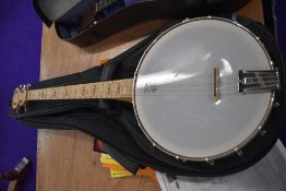 A Goodtime USA made Tenor banjo, in soft gig bag, and a selection of books
