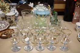 An assortment of vintage glass, including cocktail glasses, some with coloured stems and others with