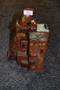 A abstract piece of glazed terracotta pottery, in the style of a cluster of buildings.