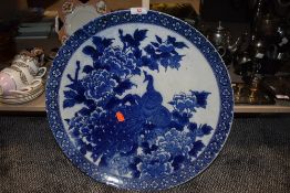 Two large Victorian Chinese export chargers in blue and white, one depicting Peacock and peonies