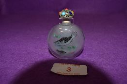 A Chinese reverse painted snuff bottle decorated with scenes of carp