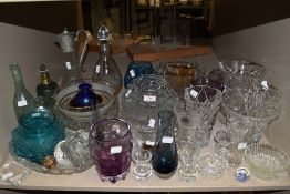 A large assortment of glass amongst which are some colourful pieces, vases,rose bowls, decanters and