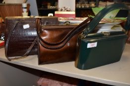 Three vintage clasp top handbags.