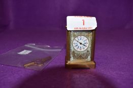 A miniature French carriage clock having visible escapement hand painted panels depicting wild