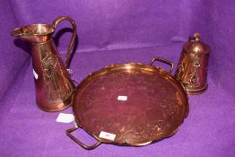 An arts and crafts copper tray with brass feet and handles to either side,jug(J.S&S.B to