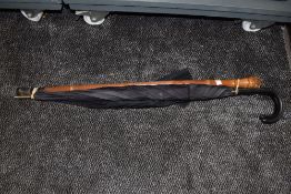 A selection of umbrella and a bamboo walking cane