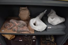 A selection of studio artworks including nude ceramic figure