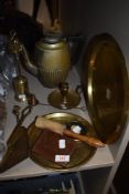 A mixed lot of brass, fire side utensils, two embossed platters a candlestick holder and more,