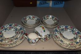 A collection of Royal Cauldon 'Victoria' plates and bowls, also a jug and cheese dish, around thirty