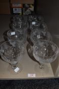 Eight large sundae glasses or dishes having etched grape vine and leaf pattern.