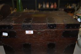 A antique oak chest having handles and bracket detailing and brass plaque to lid, key included.
