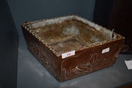 An art Nouveau lead lined planter with embossed tulip pattern.