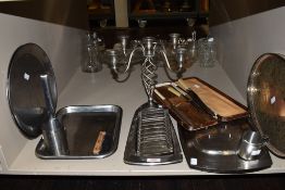 A lot containing a selection of stainless steel trays, toast rack,serving platters and vintage