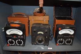An assortment of electrical testing equipment in cases.
