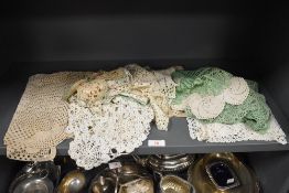 A selection of crotchet work including place and plant mats