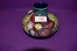 A vintage Moorcroft vase having anemone pattern on blue ground.