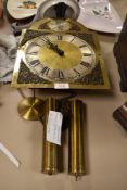 A brass faced long case clock mechanism stamped Tempus Fugit