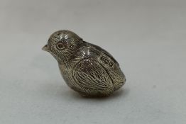 A silver pin cushion modelled as a chick, Birmingham 1921, M Bros